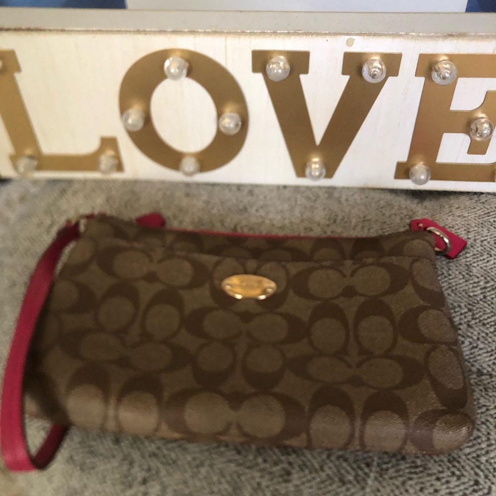 Like new worn once Pink Coach Wristlet
